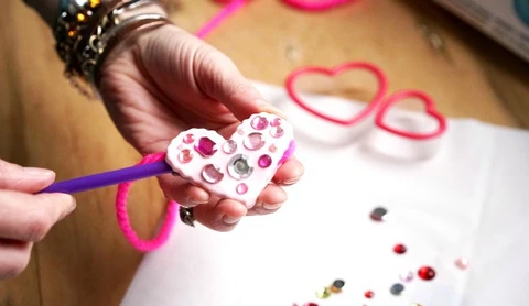 adding yarn to the kids clay pendant